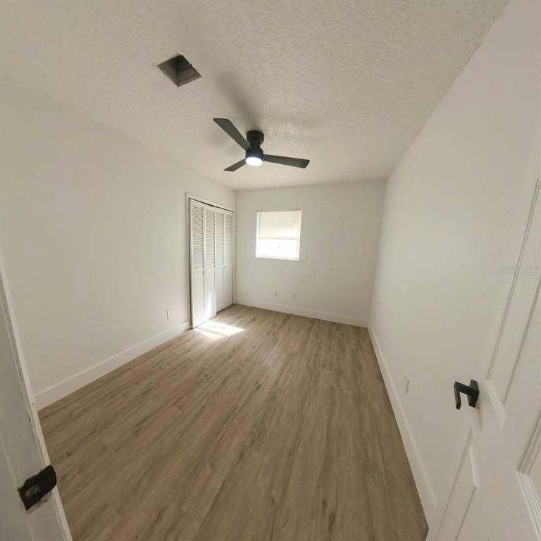905 Spring Creek Drive Ocoee, FL 34761 - Photo 31 of 43 wooden floor in an empty room with a window