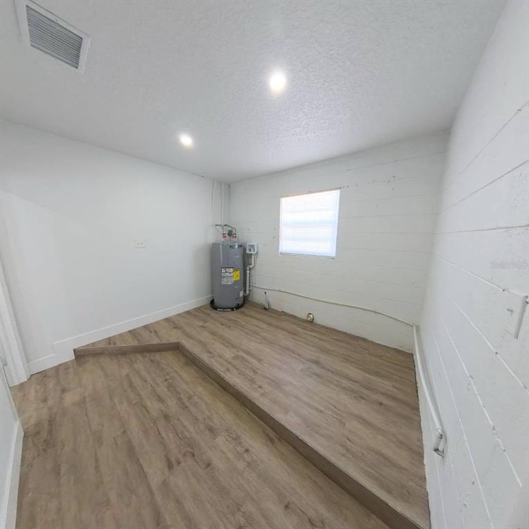 905 Spring Creek Drive Ocoee, FL 34761 - Photo 32 of 43 a view of empty room with wooden floor and fan