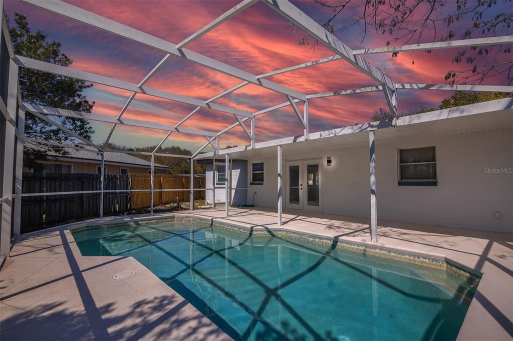 905 Spring Creek Drive Ocoee, FL 34761 - Photo 33 of 35 a view of a backyard with table and chairs and wooden fence
