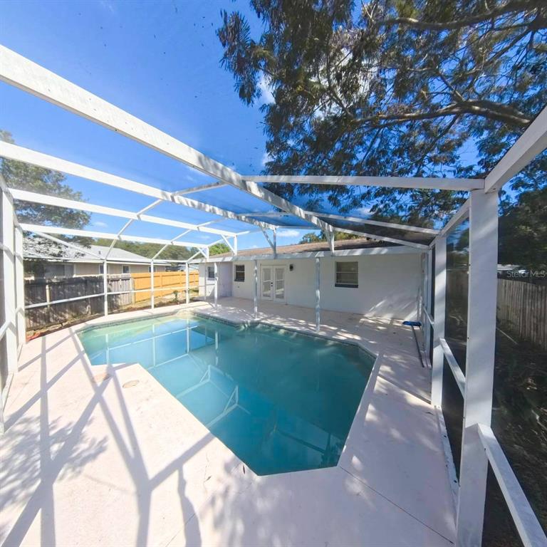 905 Spring Creek Drive Ocoee, FL 34761 - Photo 34 of 43 a view of a swimming pool with a patio