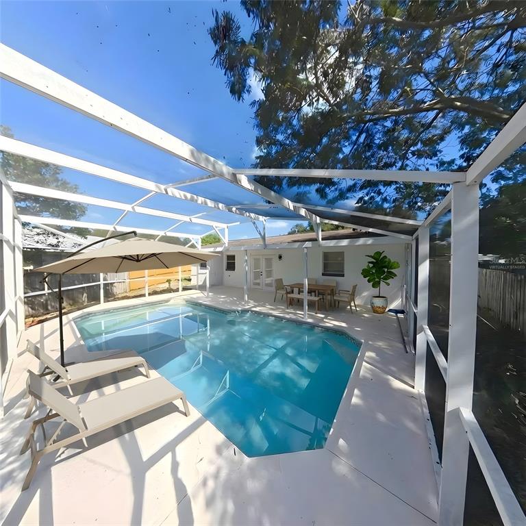 905 Spring Creek Drive Ocoee, FL 34761 - Photo 35 of 43 a view of a swimming pool with a patio
