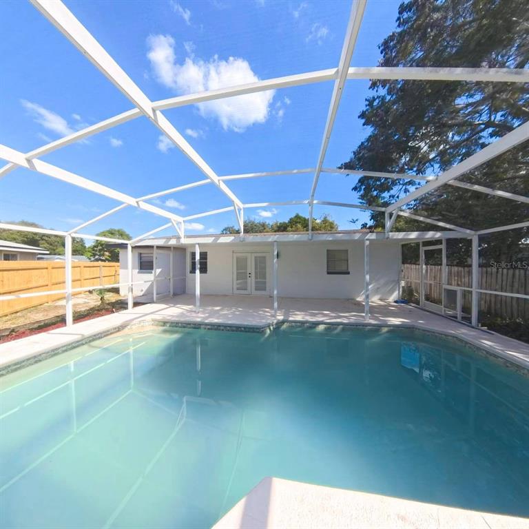 905 Spring Creek Drive Ocoee, FL 34761 - Photo 37 of 43 a view of a backyard with a swimming pool