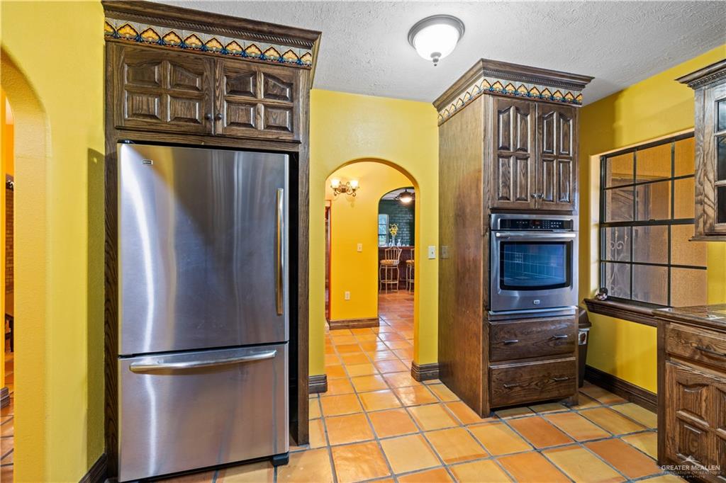 610 North Texas Street Rio Grande City, TX 78582 - Photo 10 of 23 a kitchen with stainless steel appliances granite countertop a refrigerator and a stove top oven