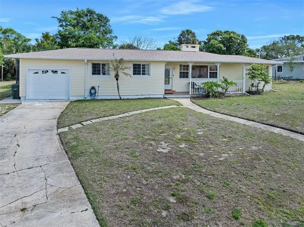 a view of a house with a yard and plants