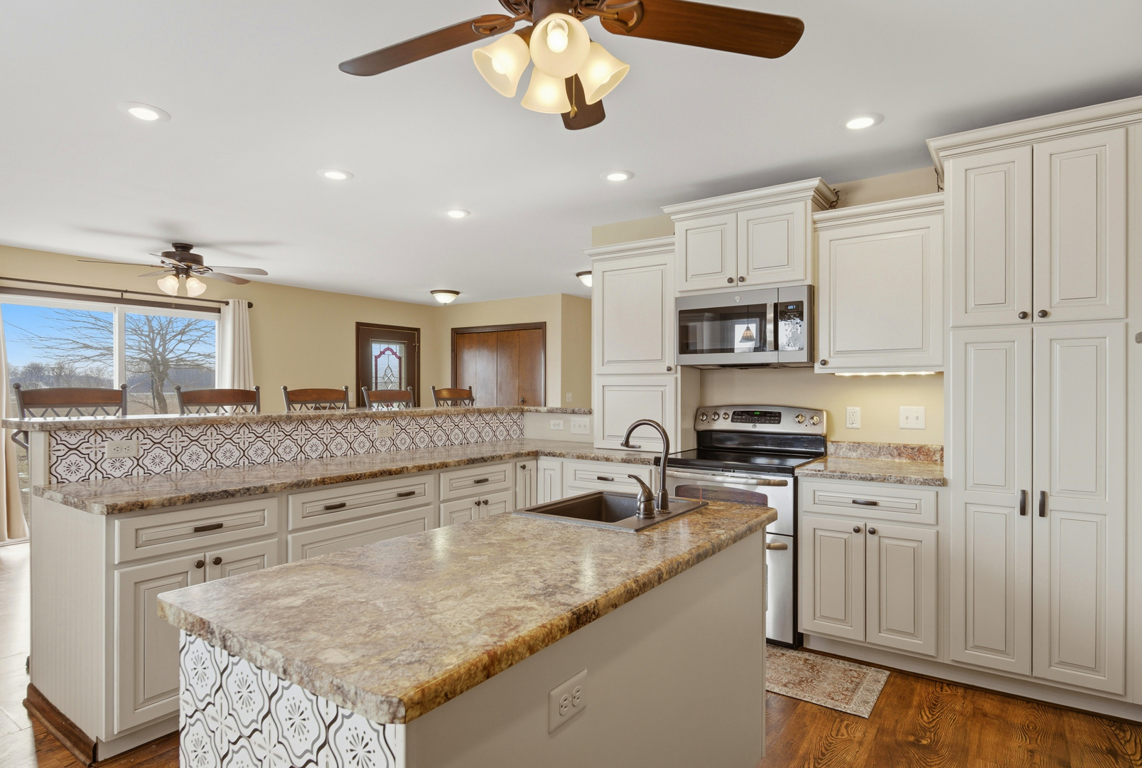 18521 Anderson Road Prophetstown, IL 61277 - Photo 15 of 39 a kitchen with stainless steel appliances granite countertop a sink a stove and a refrigerator