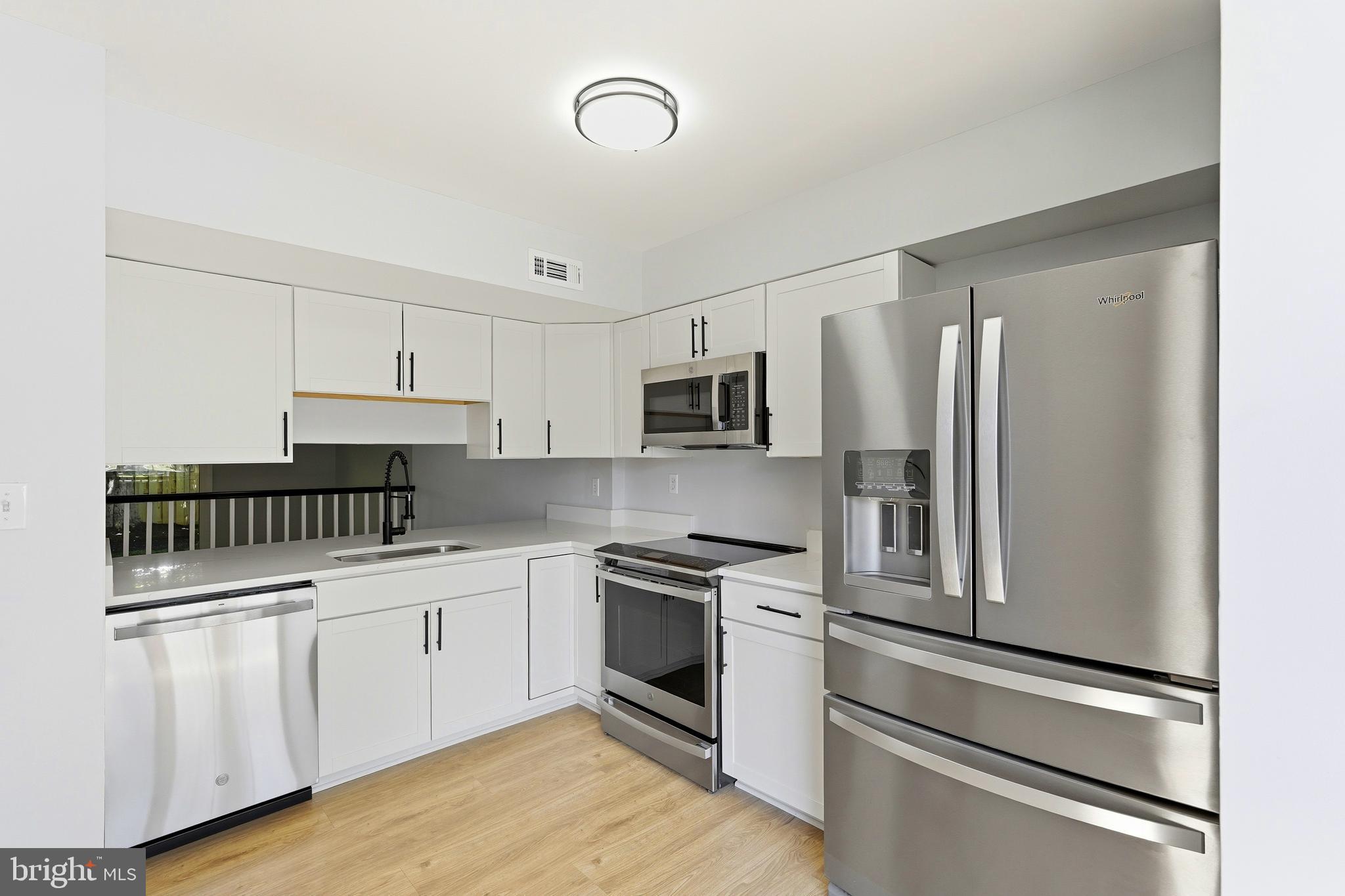 3682 Masthead Trail Triangle, VA 22172 - Photo 11 of 53 a kitchen with a sink stainless steel appliances and cabinets