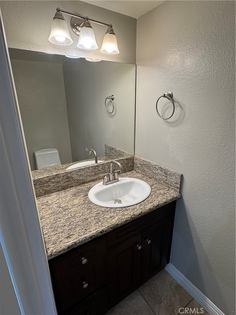 45 Harkness Avenue, Unit 2 Pasadena, CA 91106 - Photo 11 of 26 a bathroom with a granite countertop sink and a mirror
