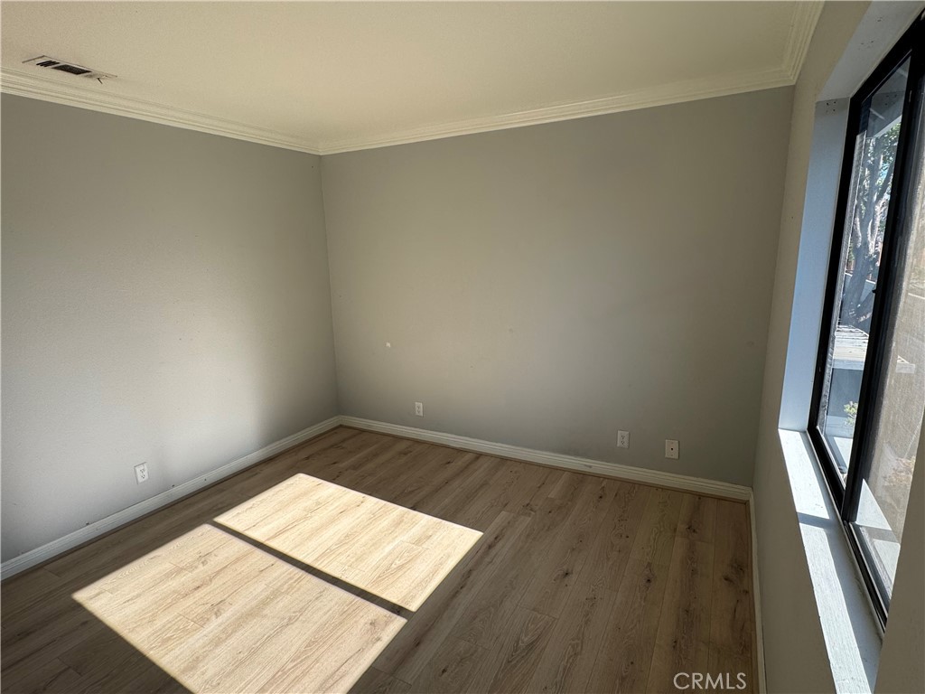 45 Harkness Avenue, Unit 2 Pasadena, CA 91106 - Photo 15 of 26 an empty room with wooden floor and windows