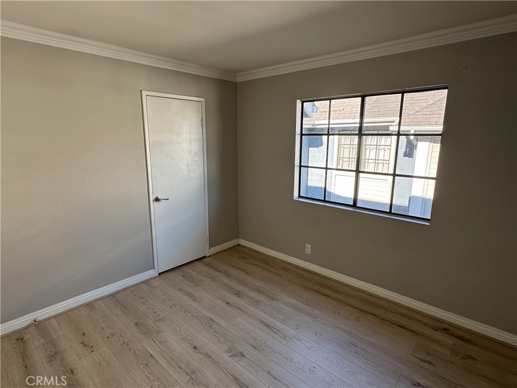45 Harkness Avenue, Unit 2 Pasadena, CA 91106 - Photo 22 of 26 an empty room with wooden floor and windows