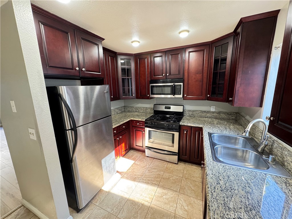 45 Harkness Avenue, Unit 2 Pasadena, CA 91106 - Photo 8 of 26 a kitchen with stainless steel appliances granite countertop a refrigerator stove and sink