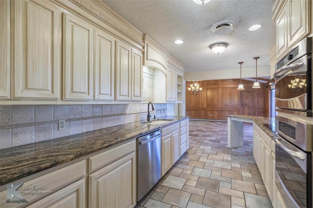 220 Hedges Road Abilene, TX 79605 - Photo 12 of 40 a kitchen with stainless steel appliances granite countertop a sink and cabinets