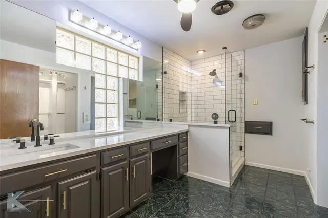 a view of a double vanity sink and a window