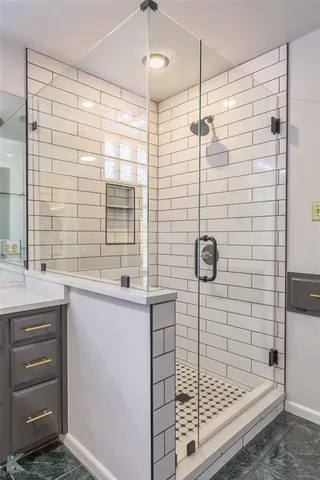 a bathroom with a shower and a sink