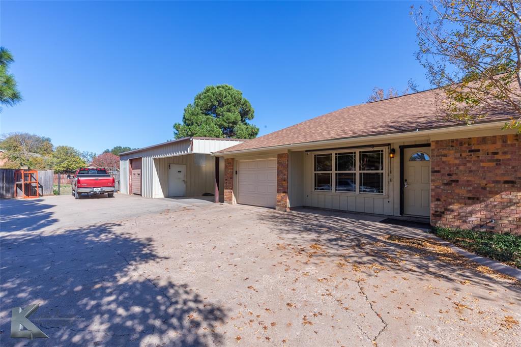 220 Hedges Road Abilene, TX 79605 - Photo 4 of 40 a front view of a house with a yard and garage