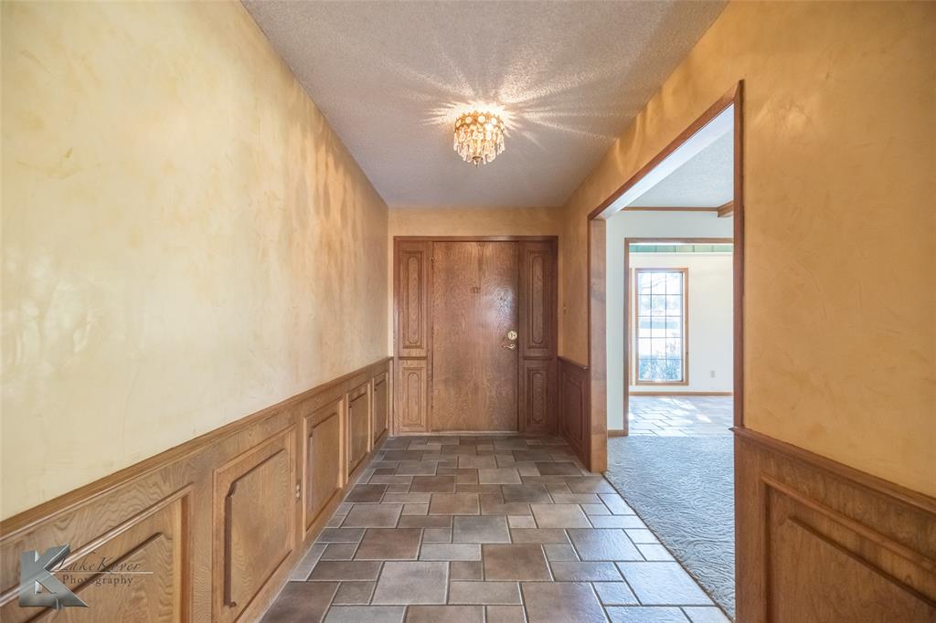 220 Hedges Road Abilene, TX 79605 - Photo 5 of 40 a view of a hallway with a chandelier