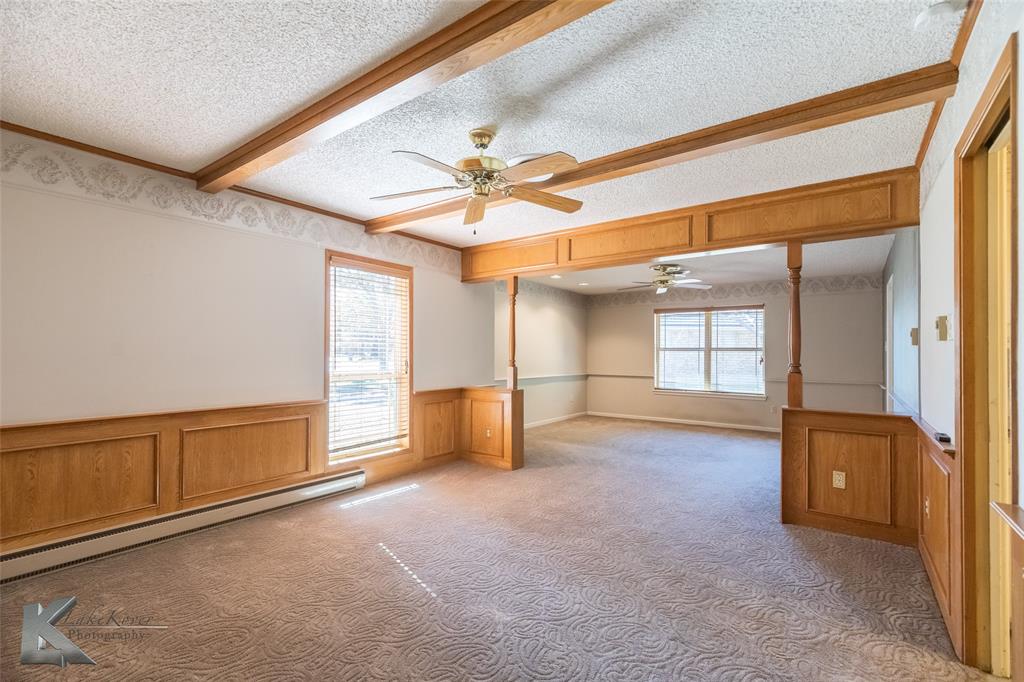 220 Hedges Road Abilene, TX 79605 - Photo 7 of 40 an empty room with windows and ceiling fan