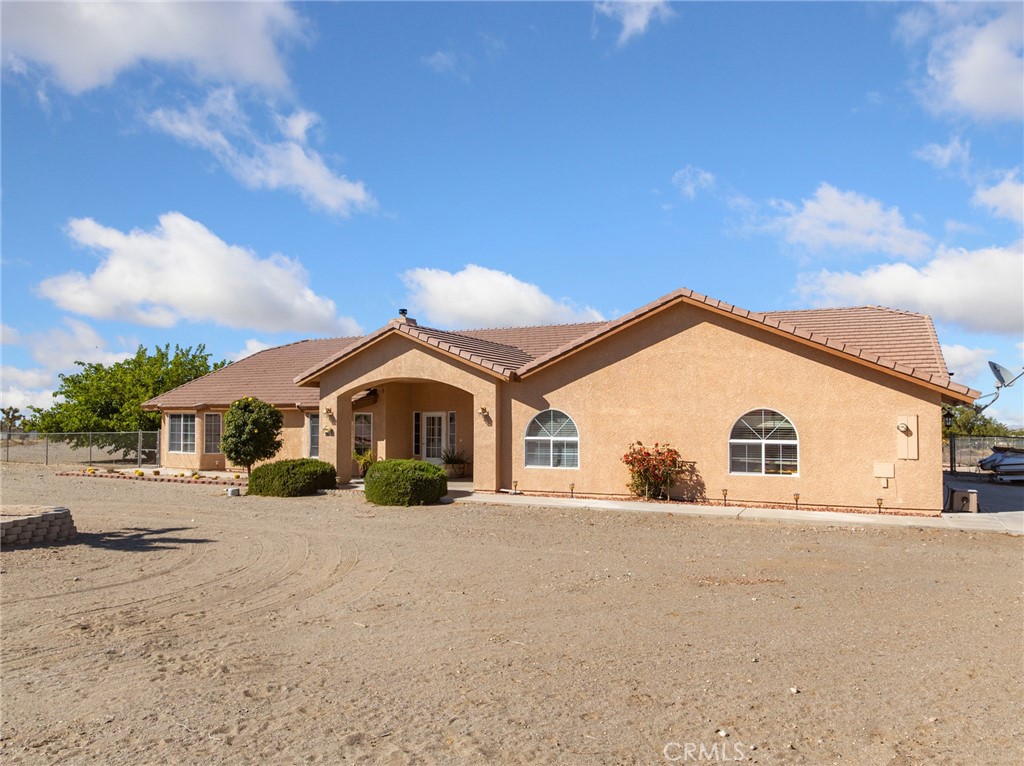 11025 El Esteban Road Phelan, CA 92371 - Photo 50 of 54 a view of a white house with a yard
