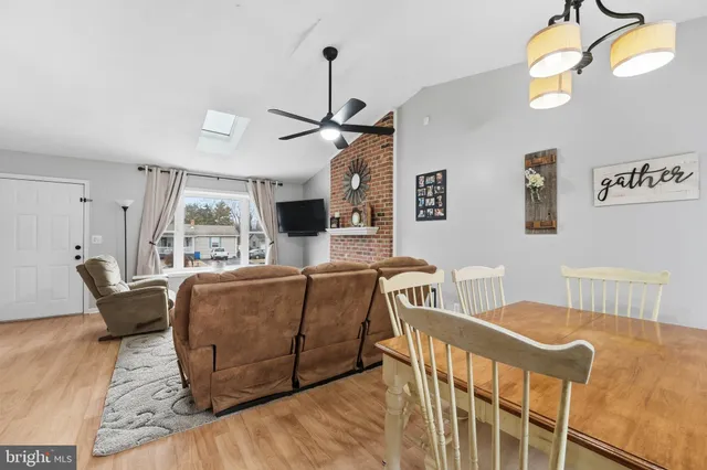 a living room with furniture a window and a chandelier