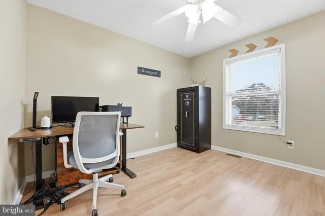 a view of workspace with wooden floor windows