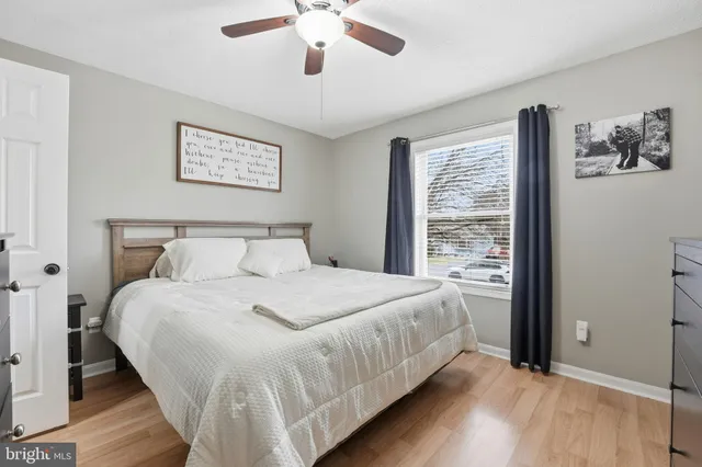 a large bed sitting in a bedroom next to a window