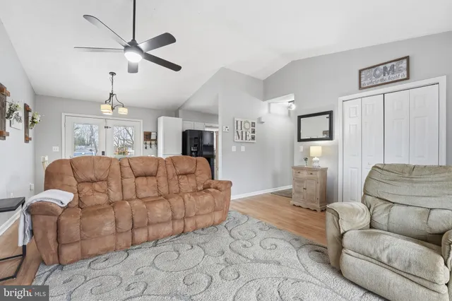 a living room with furniture and a chandelier