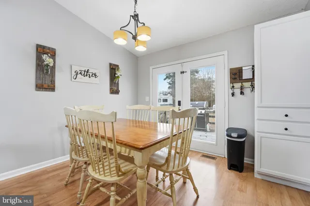 a view of a dining room with furniture and a chandelier