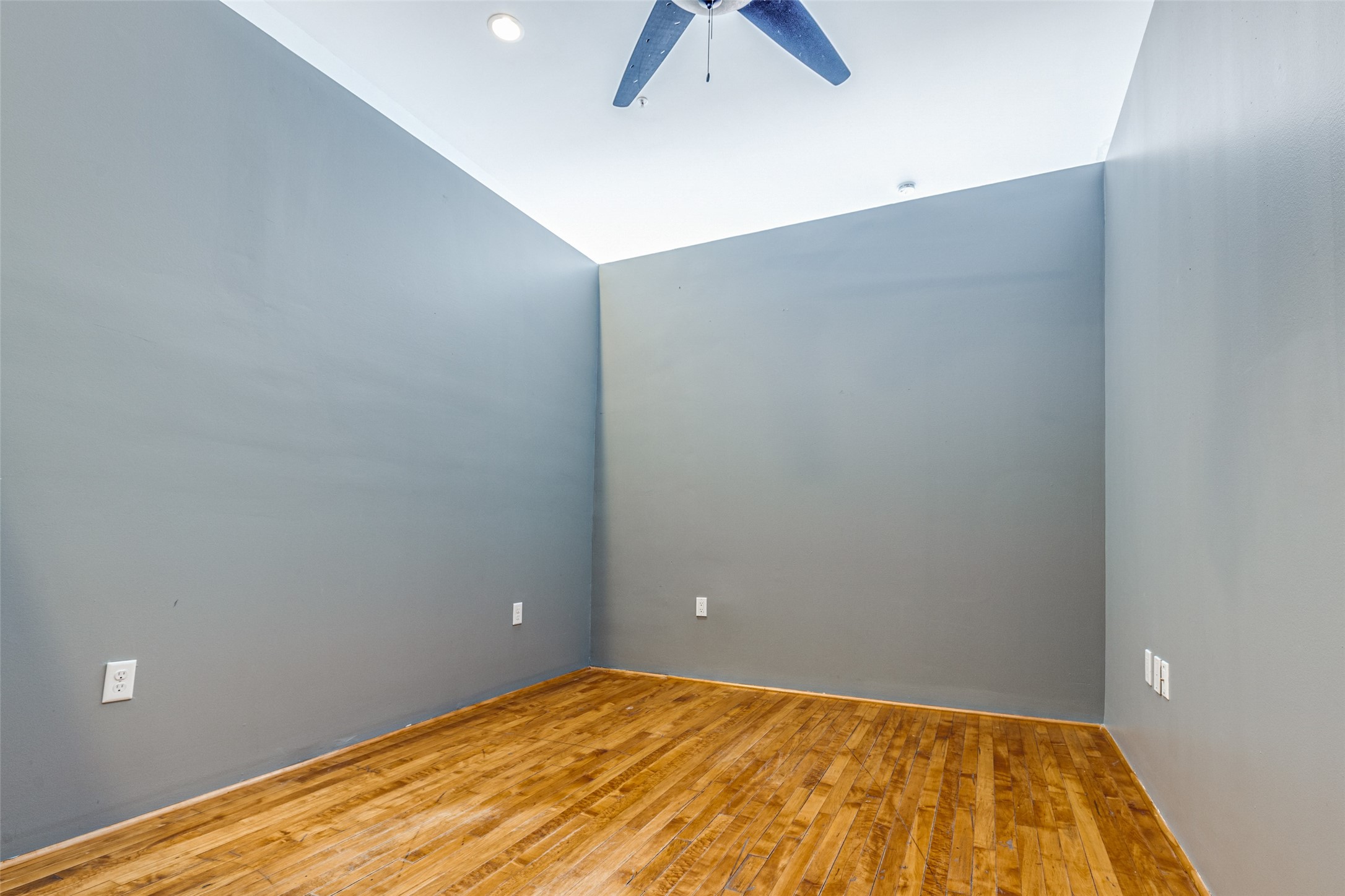 1312 Live Oak Street, Unit 223 Houston, TX 77003 - Photo 18 of 31 Secondary bedroom with hardwood floors, neutral walls, and modern overhead lighting.