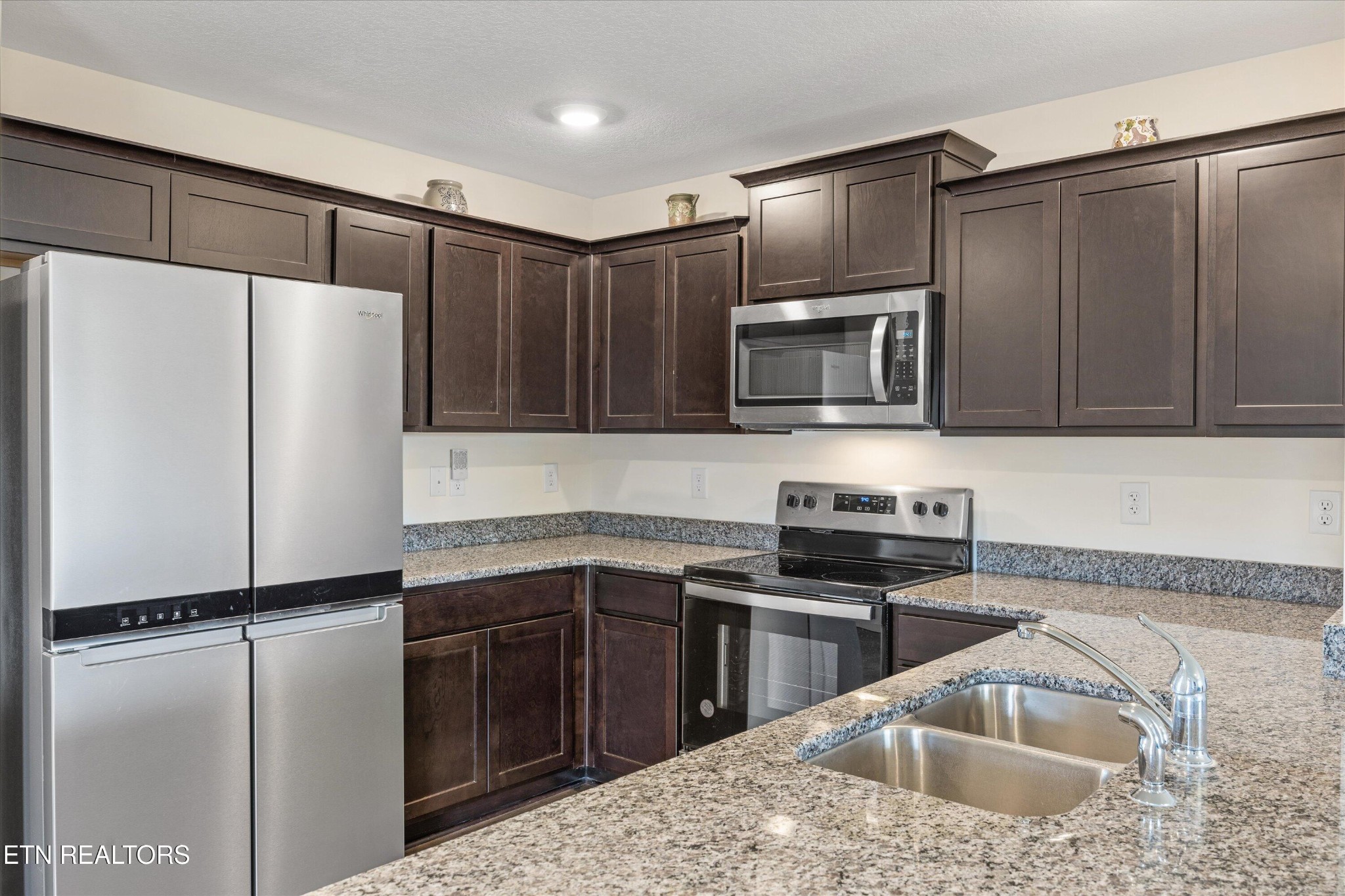 248 Belle Court Talbott, TN 37877 - Photo 11 of 36 a kitchen with granite countertop a refrigerator stove and sink