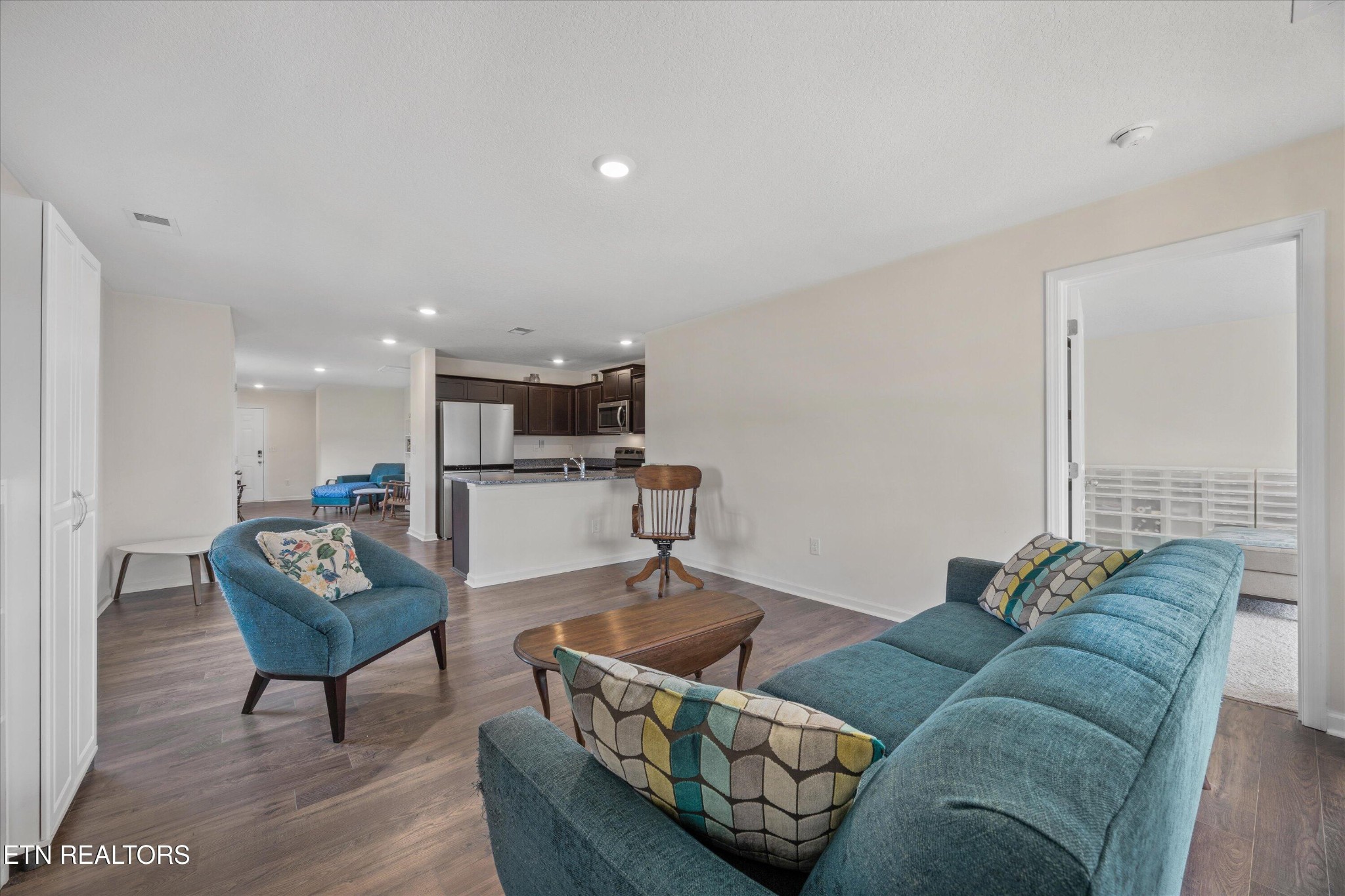 248 Belle Court Talbott, TN 37877 - Photo 17 of 36 a living room with furniture and a dining table with rug