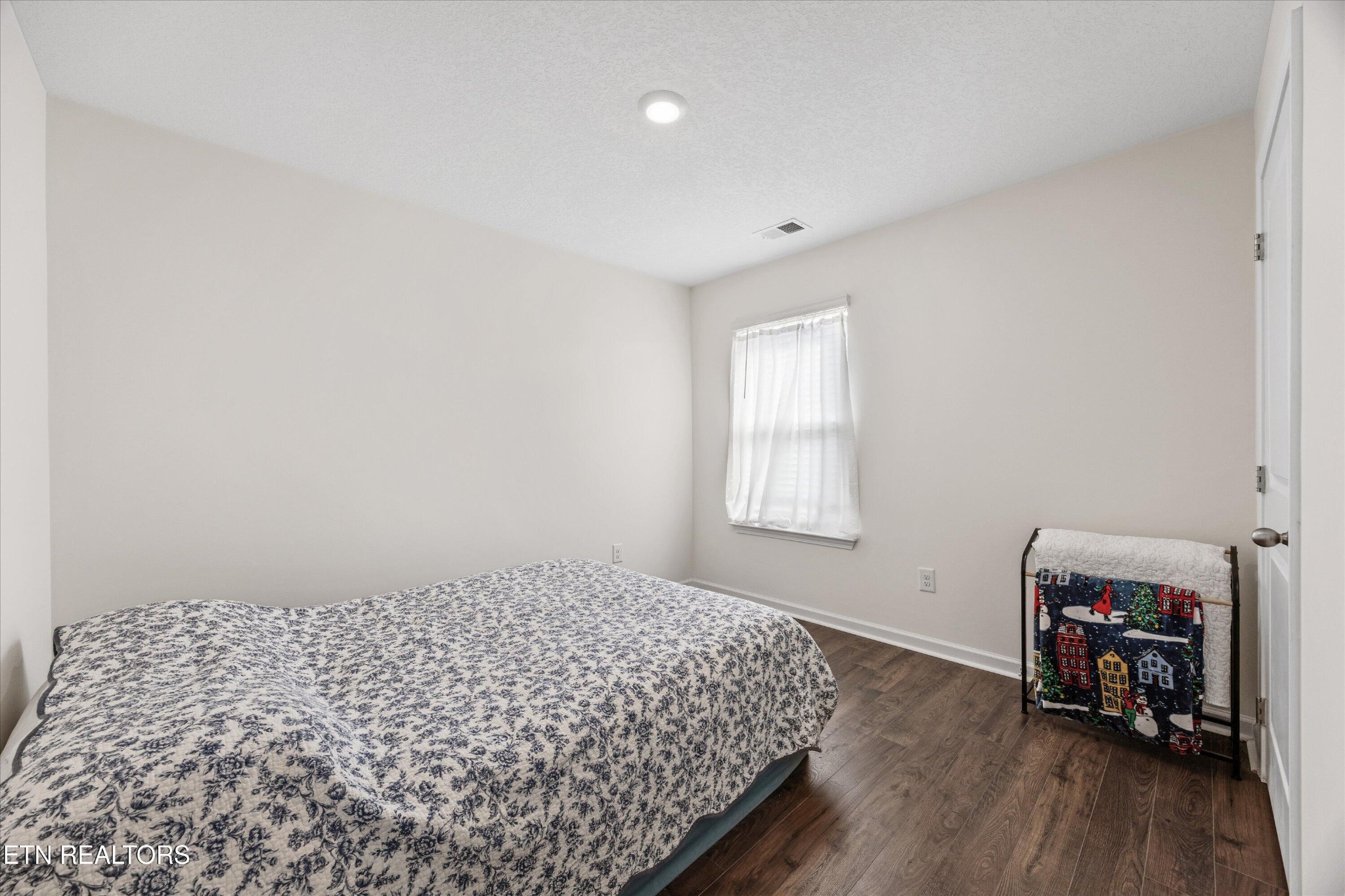 248 Belle Court Talbott, TN 37877 - Photo 19 of 36 a bedroom with a bed and a wooden floor