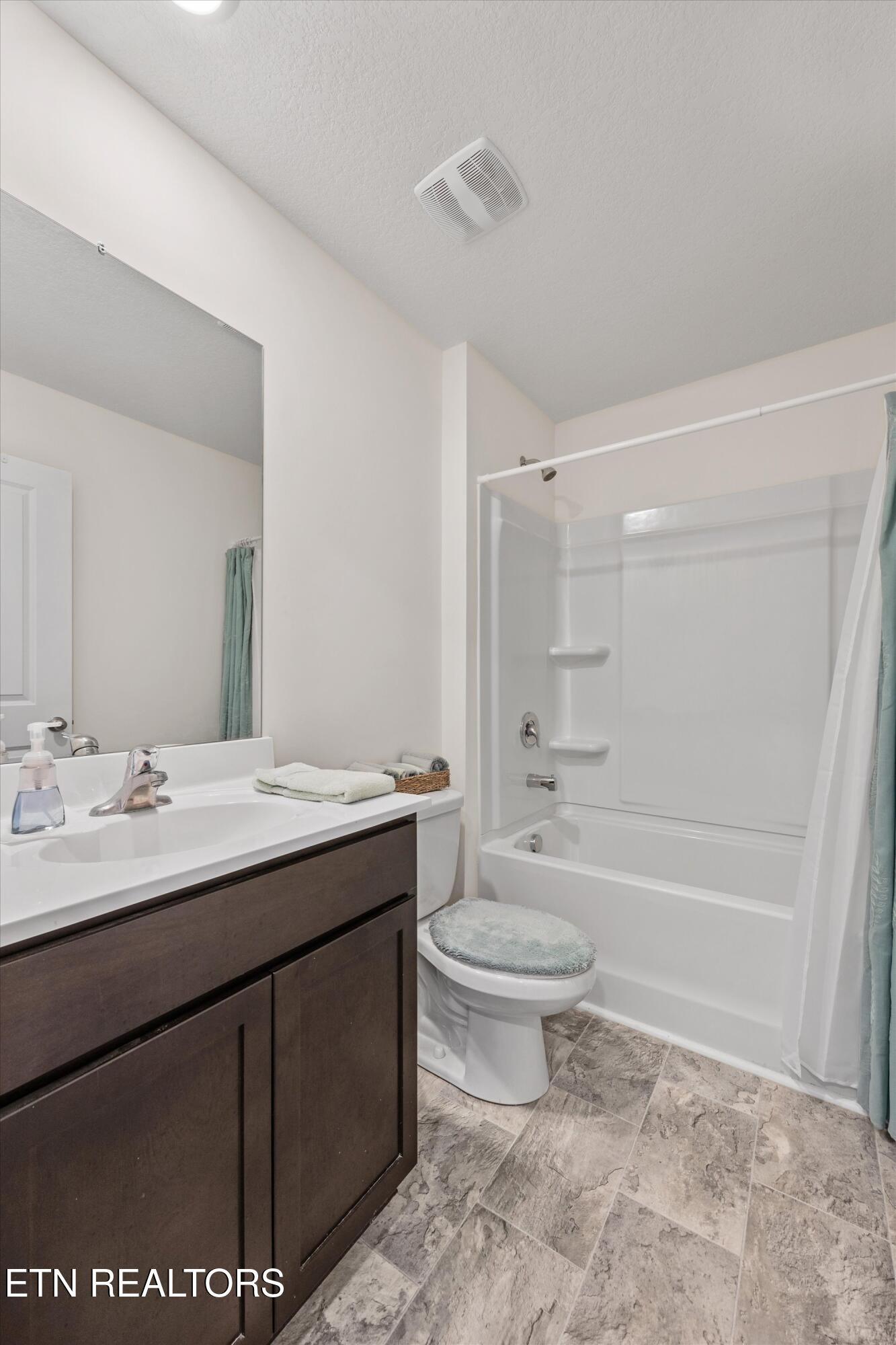 248 Belle Court Talbott, TN 37877 - Photo 20 of 36 a bathroom with a granite countertop sink toilet mirror and bathtub