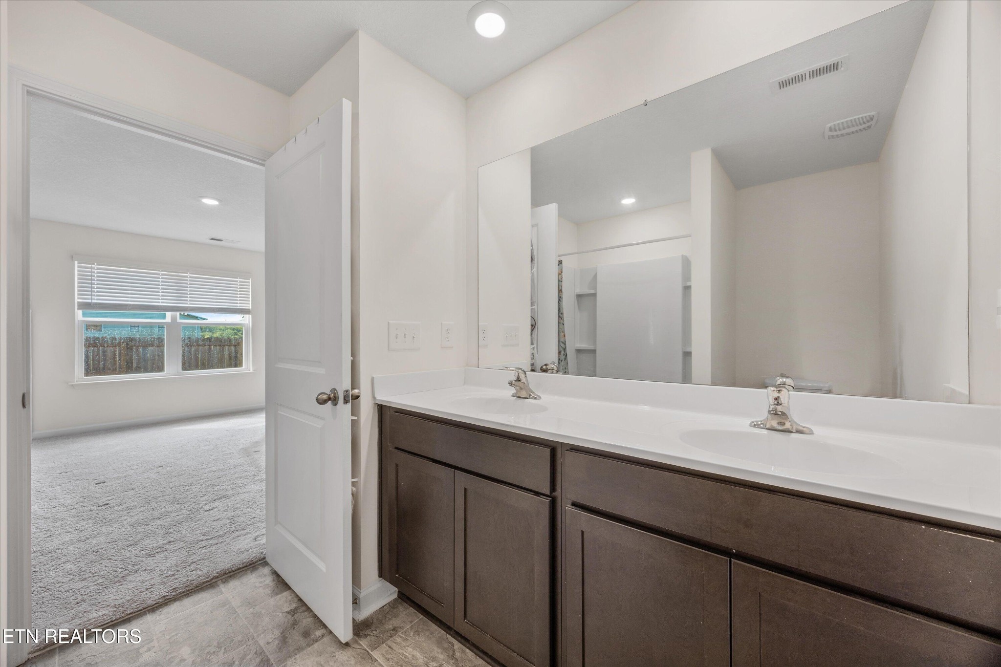 248 Belle Court Talbott, TN 37877 - Photo 25 of 36 a bathroom with a double vanity sink and a mirror