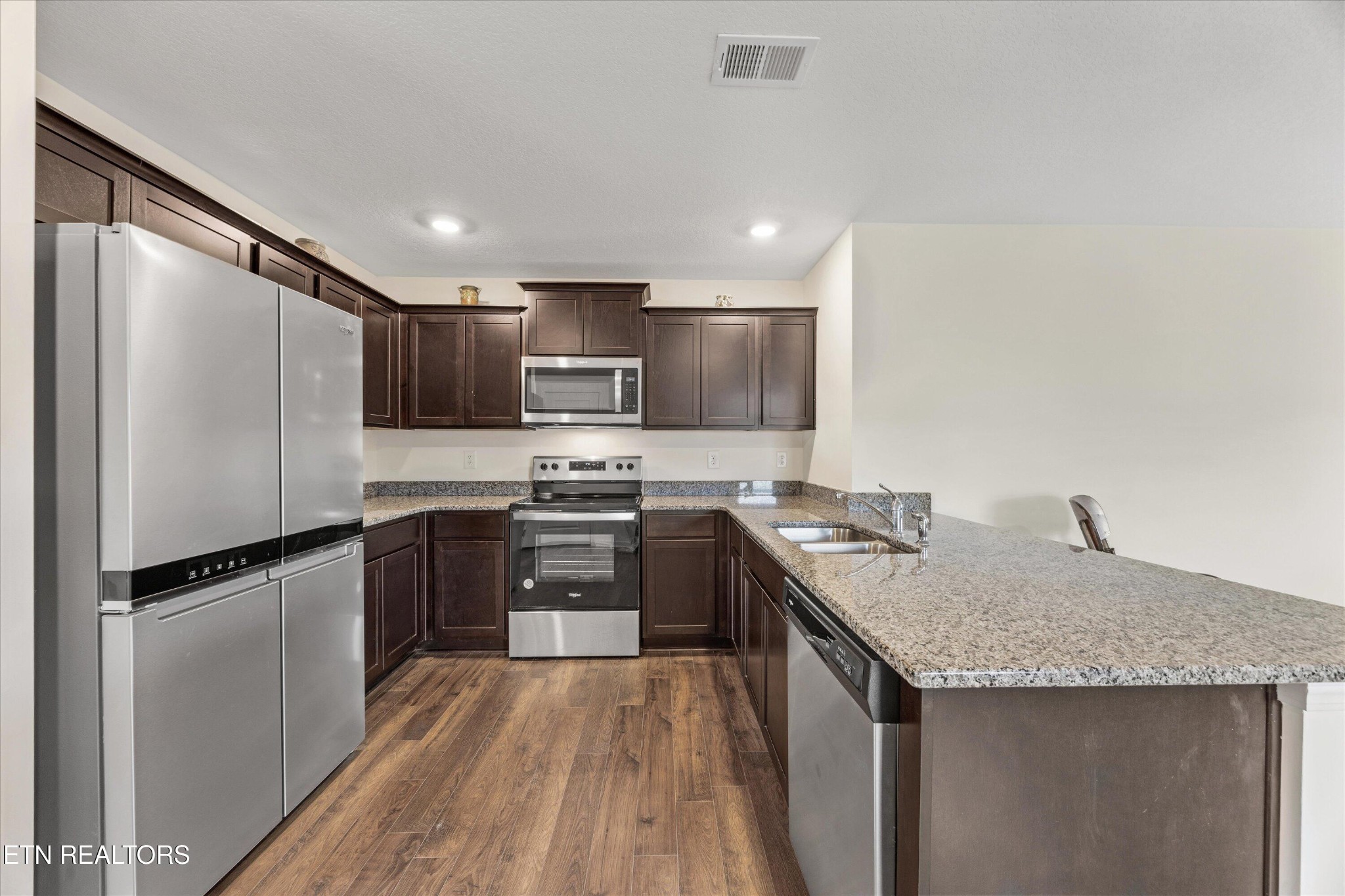 248 Belle Court Talbott, TN 37877 - Photo 10 of 36 a kitchen with a sink a counter top space stainless steel appliances and cabinets