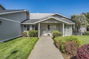 542 South Summit Street Colville, WA 99114 - Photo 1 of 10 a view of a house with brick walls and a yard with plants