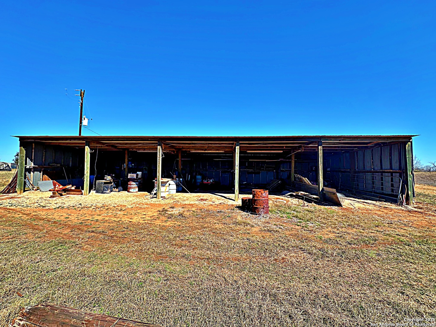 3265 Highway 97 Jourdanton, TX 78026 - Photo 3 of 24 a front view of a house with a yard and garage