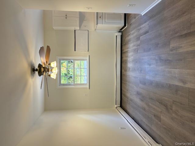 31 C Alpine Drive Wappingers Falls, NY 12590 - Photo 6 of 19 an empty room with wooden floor cabinet and a window