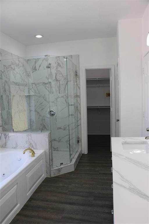 2858 Waters Edge Quinlan, TX 75474 - Photo 13 of 34 a bathroom with a bathtub and a sink