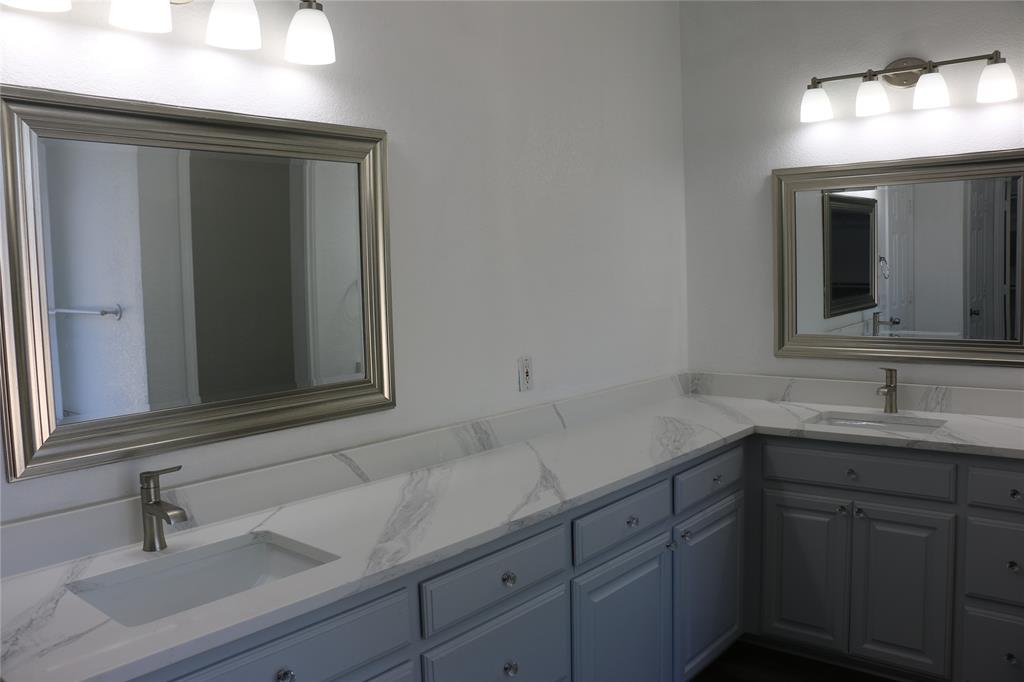 2858 Waters Edge Quinlan, TX 75474 - Photo 14 of 34 a bathroom with a sink and a mirror