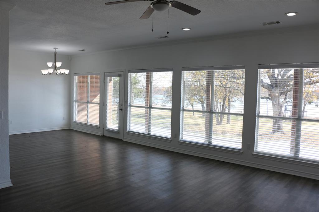 2858 Waters Edge Quinlan, TX 75474 - Photo 17 of 34 an empty room with wooden floor and windows