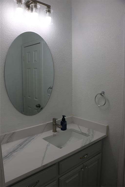 2858 Waters Edge Quinlan, TX 75474 - Photo 20 of 34 a bathroom with a sink vanity and mirror