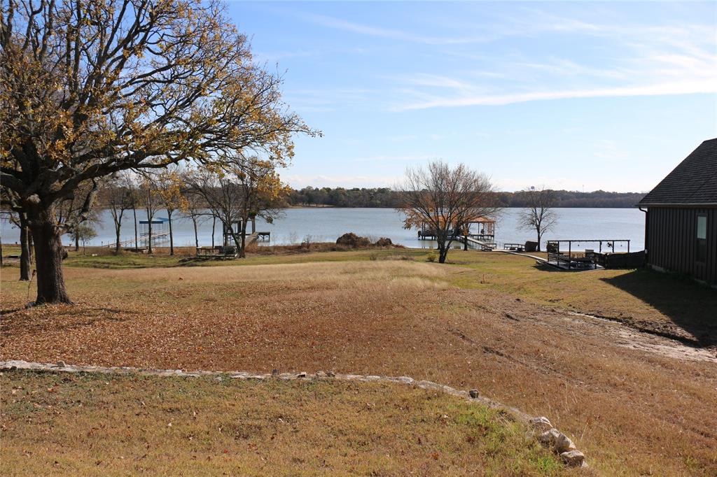 2858 Waters Edge Quinlan, TX 75474 - Photo 2 of 34 a view of road with large trees