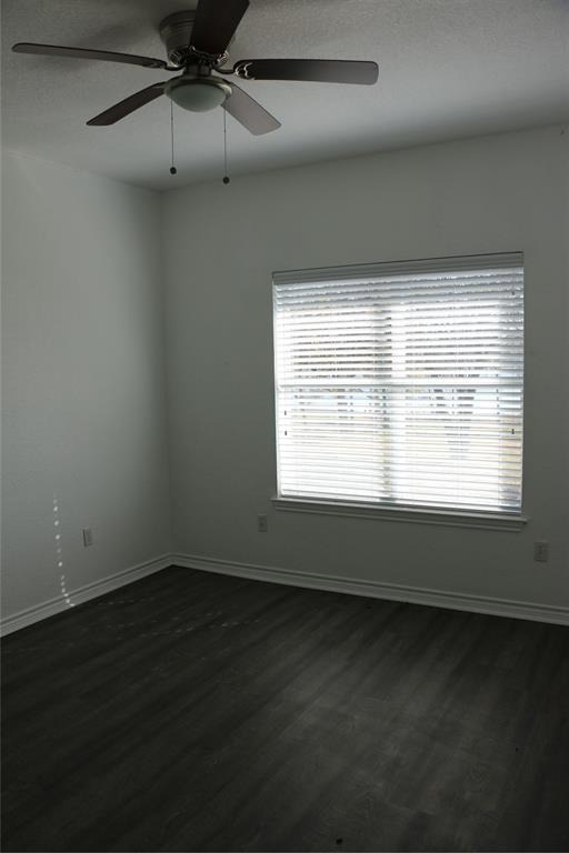 2858 Waters Edge Quinlan, TX 75474 - Photo 21 of 34 en empty room with wooden floor and windows