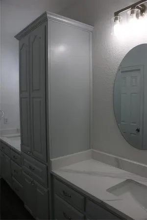 a bathroom with a shower and vanity