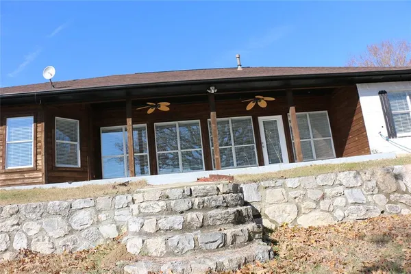 a view of a lake with chairs in roof deck