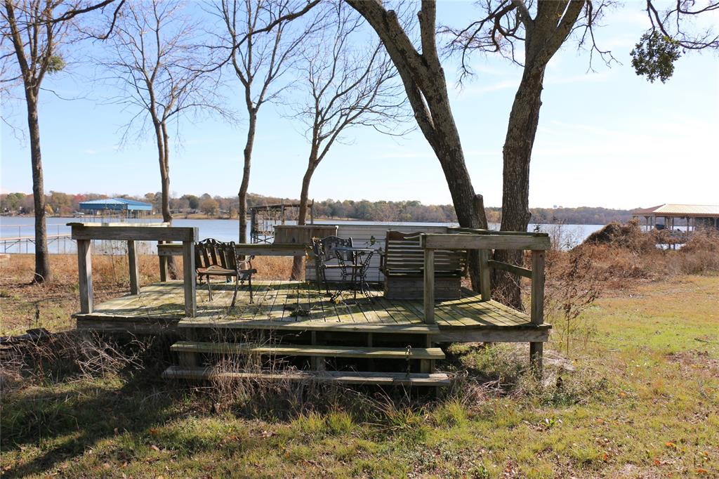 2858 Waters Edge Quinlan, TX 75474 - Photo 28 of 34 a view of a lake with chairs in roof deck