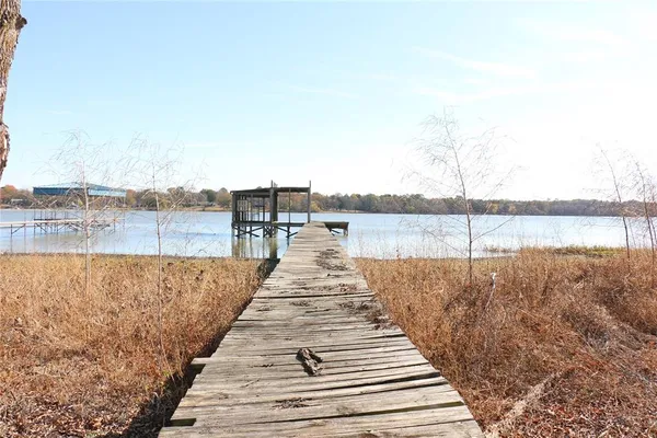 a front view of house with yard and trees around