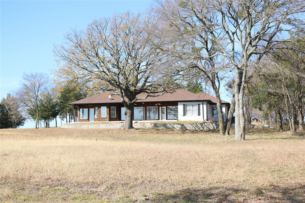 2858 Waters Edge Quinlan, TX 75474 - Photo 34 of 34 a front view of house with yard and trees around