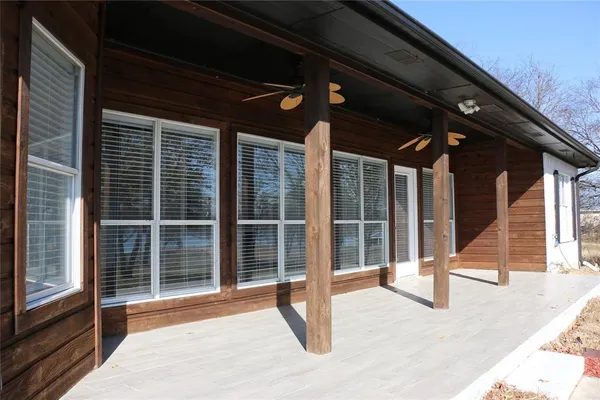 a view of a porch with a floor to ceiling window and stairs