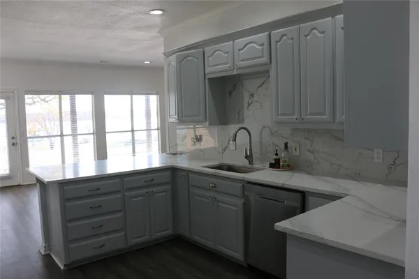 a kitchen with a sink and cabinets