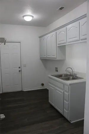 a view of a kitchen with sink and cabinets